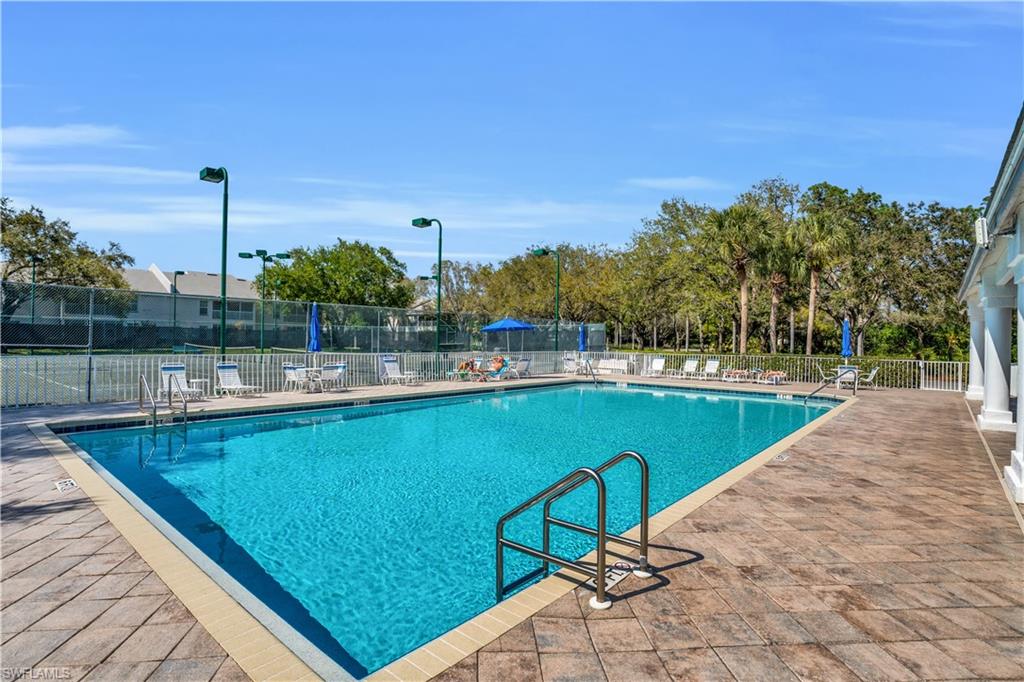 5049 Fairhaven Lane Naples, FL 34109 - Photo 35 of 46 a view of a swimming pool with a lawn chairs