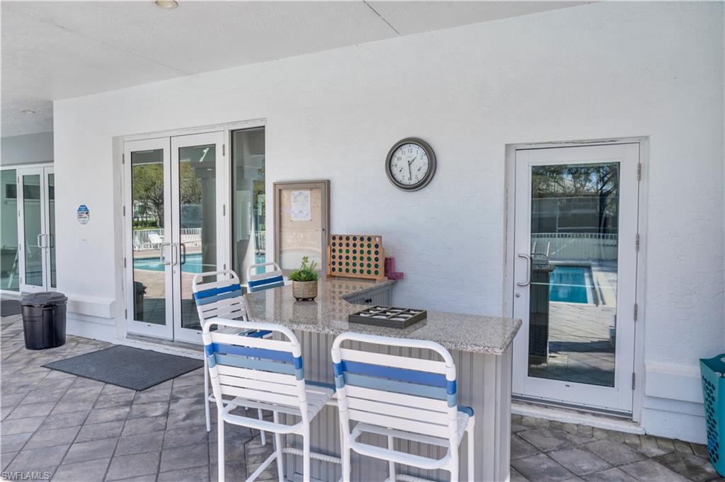 5049 Fairhaven Lane Naples, FL 34109 - Photo 39 of 46 a dining room with furniture and a window