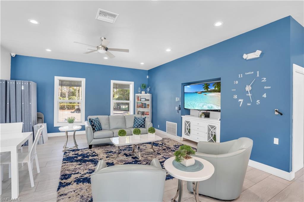 5049 Fairhaven Lane Naples, FL 34109 - Photo 41 of 46 a living room with furniture a large window and a dining table