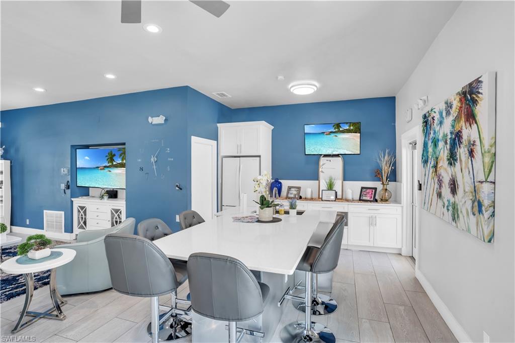 5049 Fairhaven Lane Naples, FL 34109 - Photo 42 of 46 a dining room with furniture and wooden floor