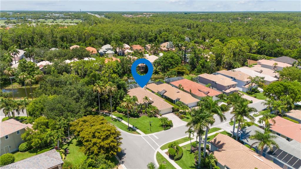 5049 Fairhaven Lane Naples, FL 34109 - Photo 5 of 46 an aerial view of a house with a yard and lake view