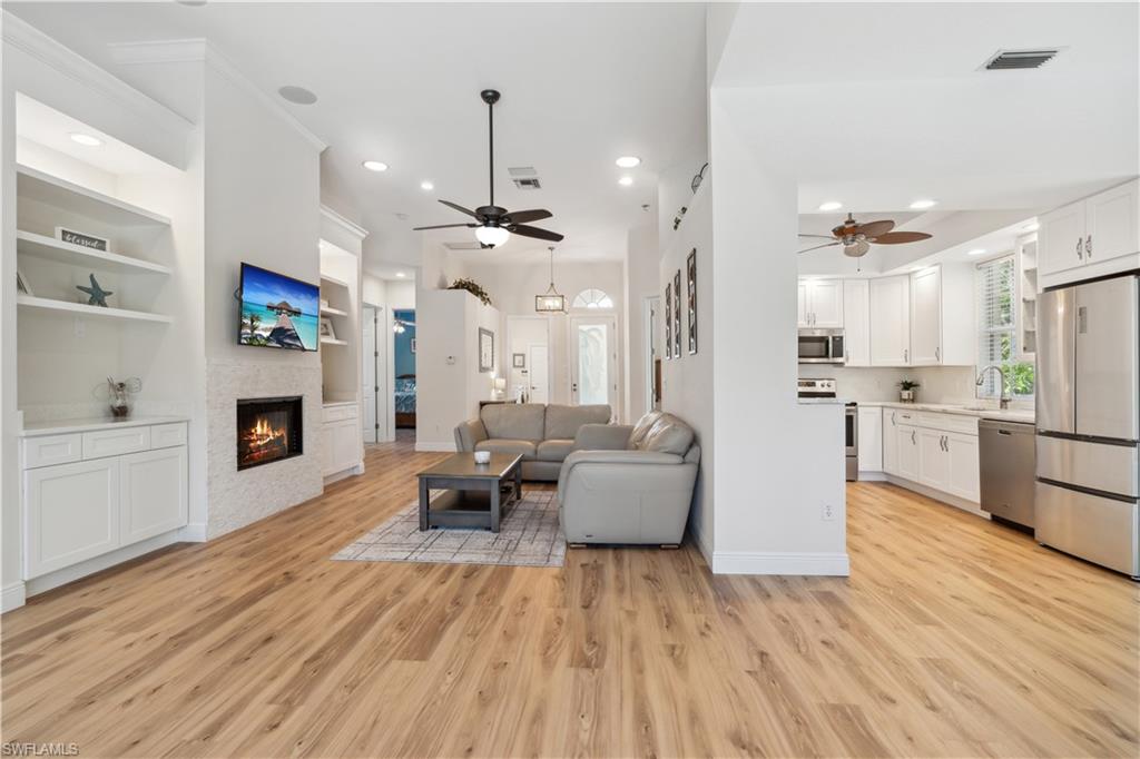 5049 Fairhaven Lane Naples, FL 34109 - Photo 7 of 46 a living room with furniture and a fireplace
