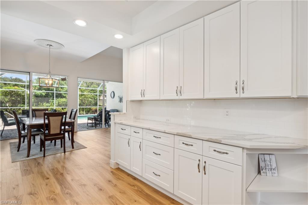 5049 Fairhaven Lane Naples, FL 34109 - Photo 10 of 46 a view of a kitchen with furniture and wooden floor