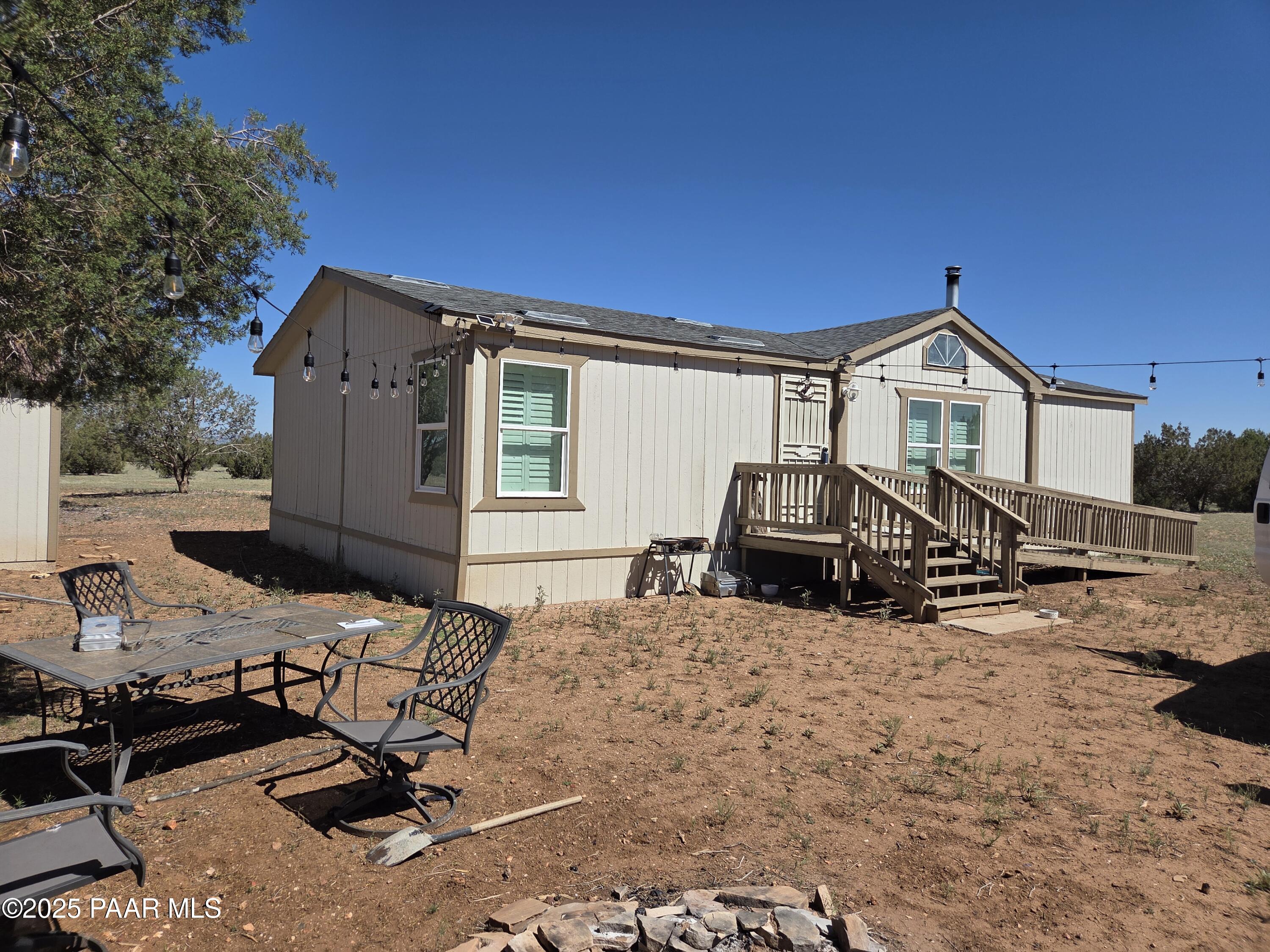 a view of a house with backyard stove and sitting area