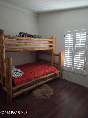 a bed sitting in a bedroom next to a window