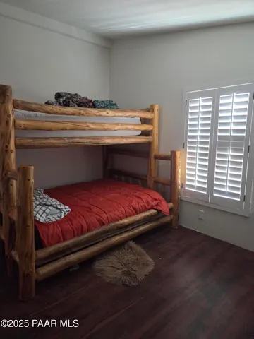 a bed sitting in a bedroom next to a window
