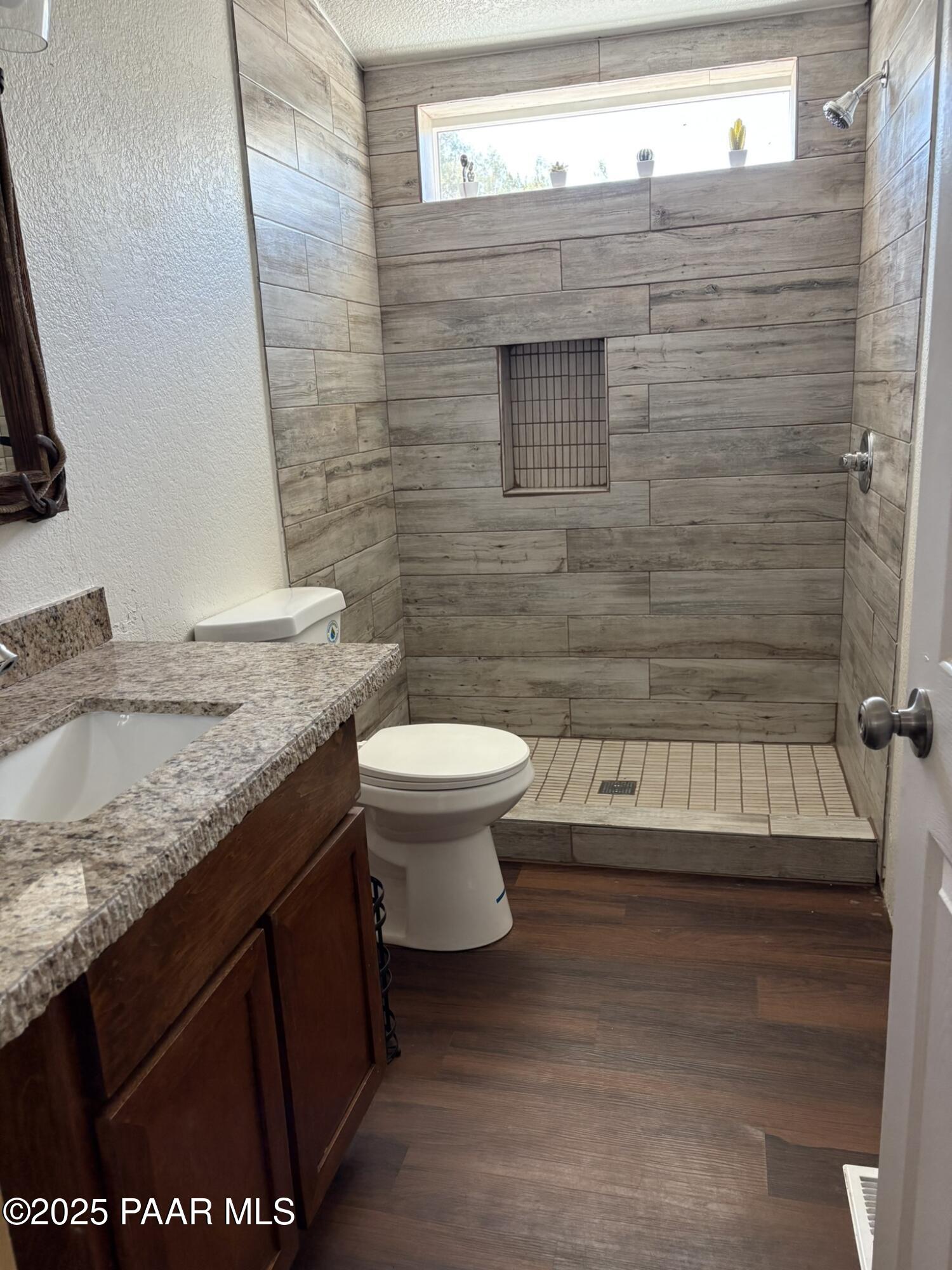 42650 North Wayne Road Ash Fork, AZ 86320 - Photo 23 of 37 a bathroom with a granite countertop sink toilet and shower
