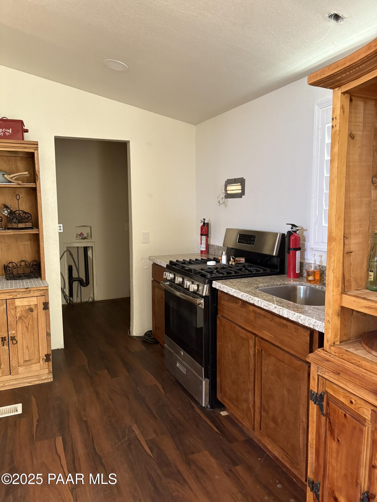 42650 North Wayne Road Ash Fork, AZ 86320 - Photo 27 of 37 a kitchen with stainless steel appliances granite countertop a stove and a refrigerator