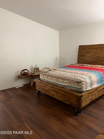 a bedroom with furniture and a wooden floor