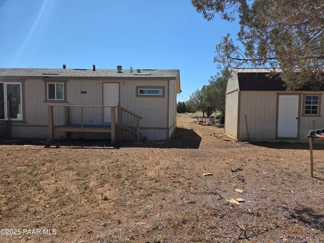 a view of a house with a snow in the background