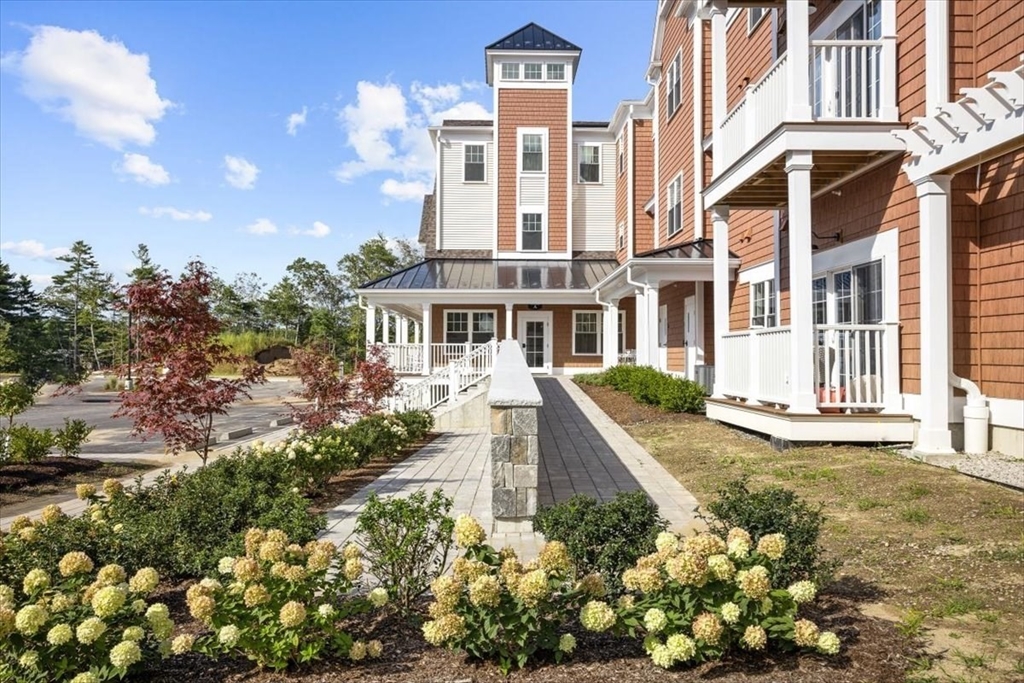 57 Long Point Road, Unit 210 Lakeville, MA 02347 - Photo 3 of 27 a front view of a multi story residential apartment building