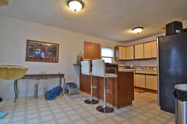 a kitchen with stainless steel appliances granite countertop a refrigerator and a stove top oven