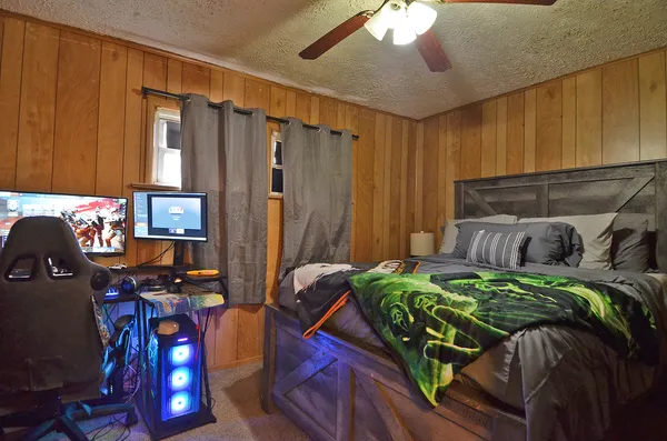 a bedroom with two bed and a window