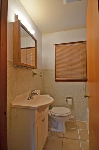 a bathroom with a sink a toilet and mirror
