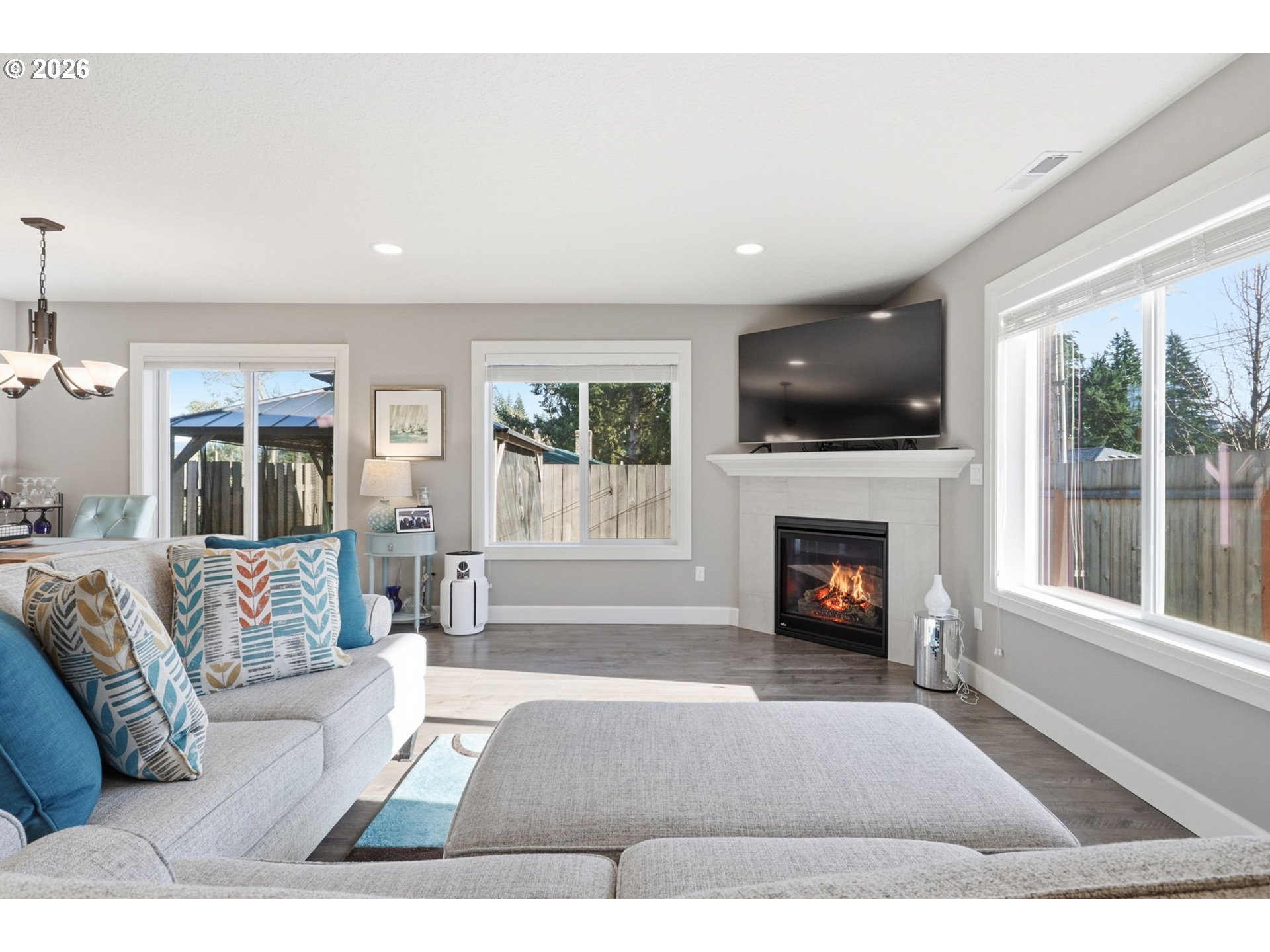 16994 University Avenue Sandy, OR 97055 - Photo 2 of 22 a living room with furniture a fireplace and a flat screen tv