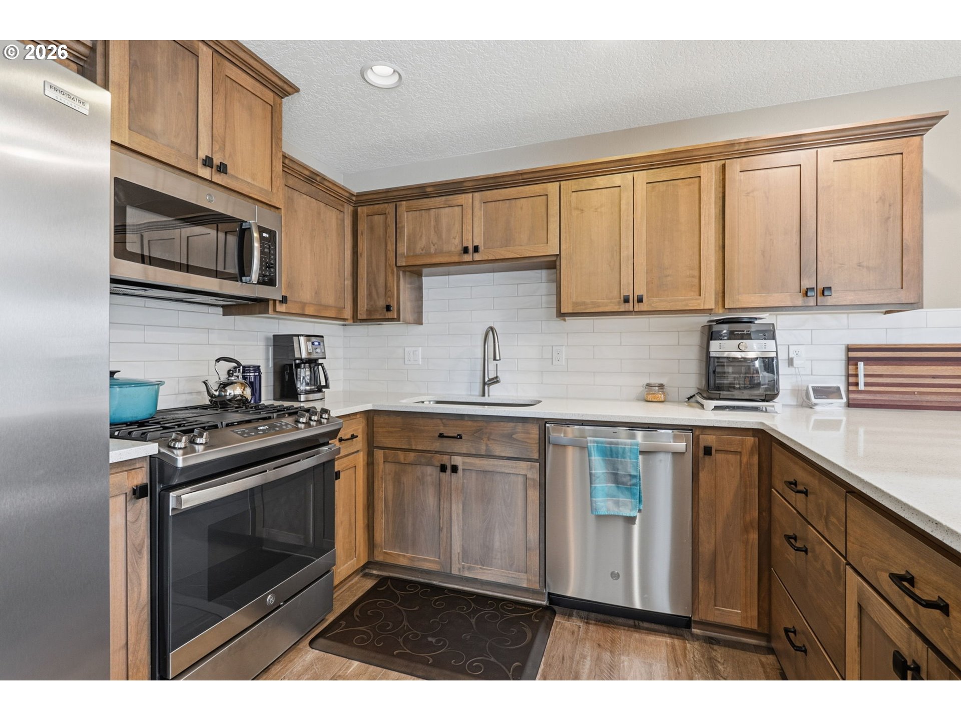 16994 University Avenue Sandy, OR 97055 - Photo 3 of 22 a kitchen with stainless steel appliances granite countertop a stove a sink dishwasher and a microwave oven with cabinets