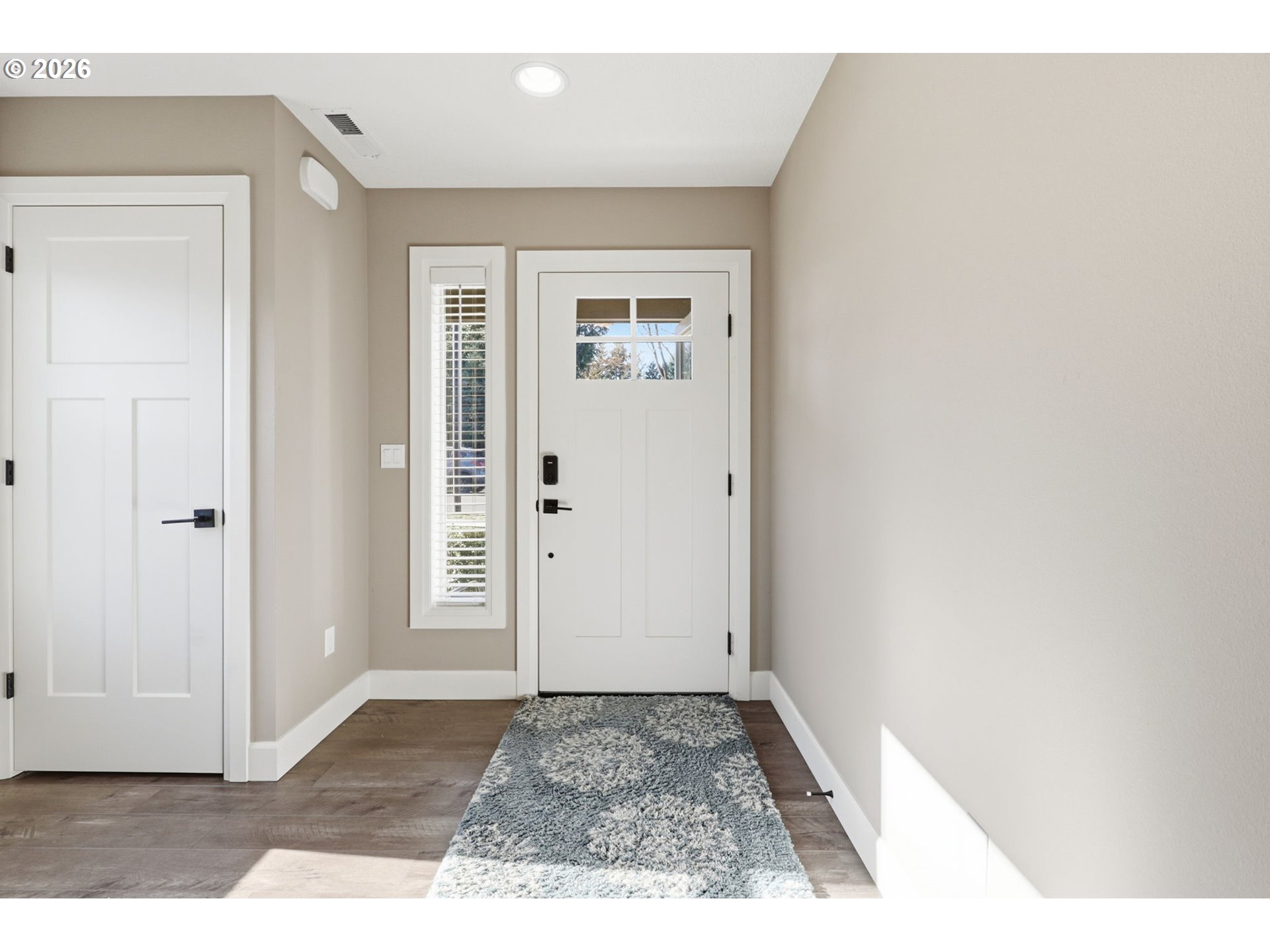 16994 University Avenue Sandy, OR 97055 - Photo 4 of 22 a view of a hallway with wooden floor and a living room