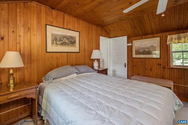 a bedroom with a bed and a lamp