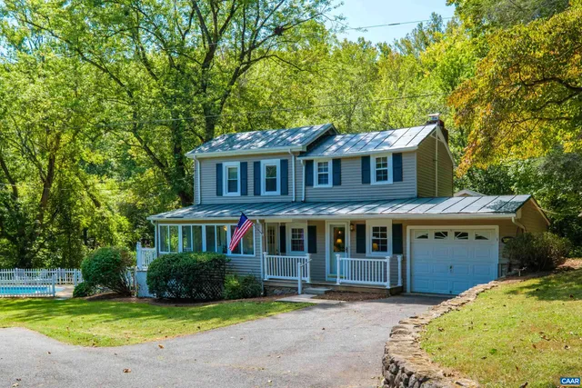 a front view of a house with a garden and yard