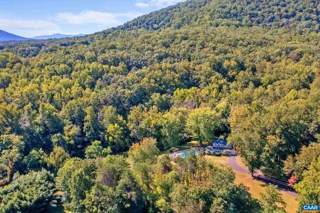 a view of a lush green hillside and a building