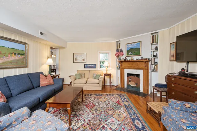 a living room with furniture flat screen tv and a fireplace