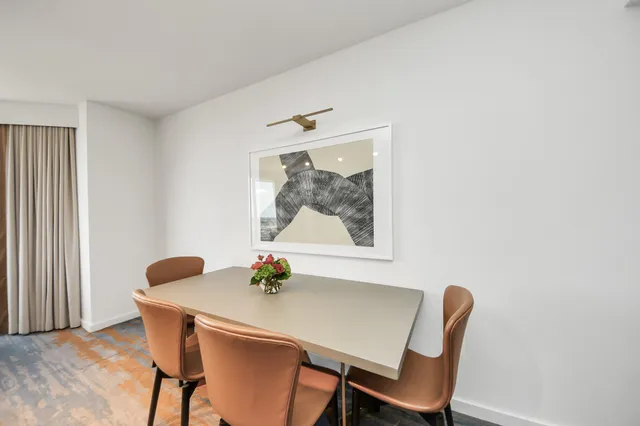 a view of a dining room with furniture and window