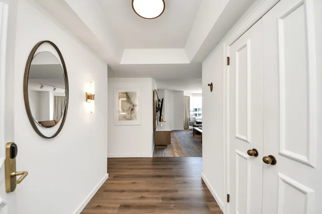 a view of a room with wooden floor and white walls