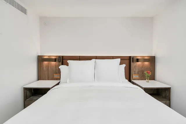 a bedroom with a bed and lamp