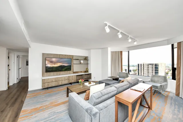 a living room with furniture and a flat screen tv