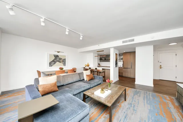 a living room with furniture and wooden floor