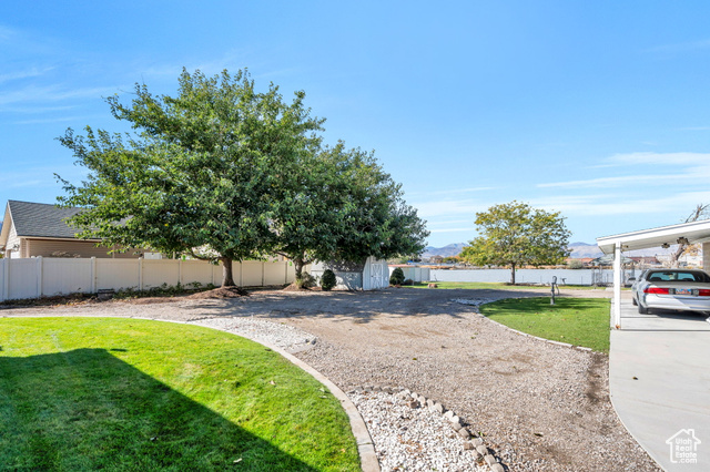 12958 South 300 East Draper, UT 84020 - Photo 15 of 38 Fenced backyard with a storage unit and a mountain view