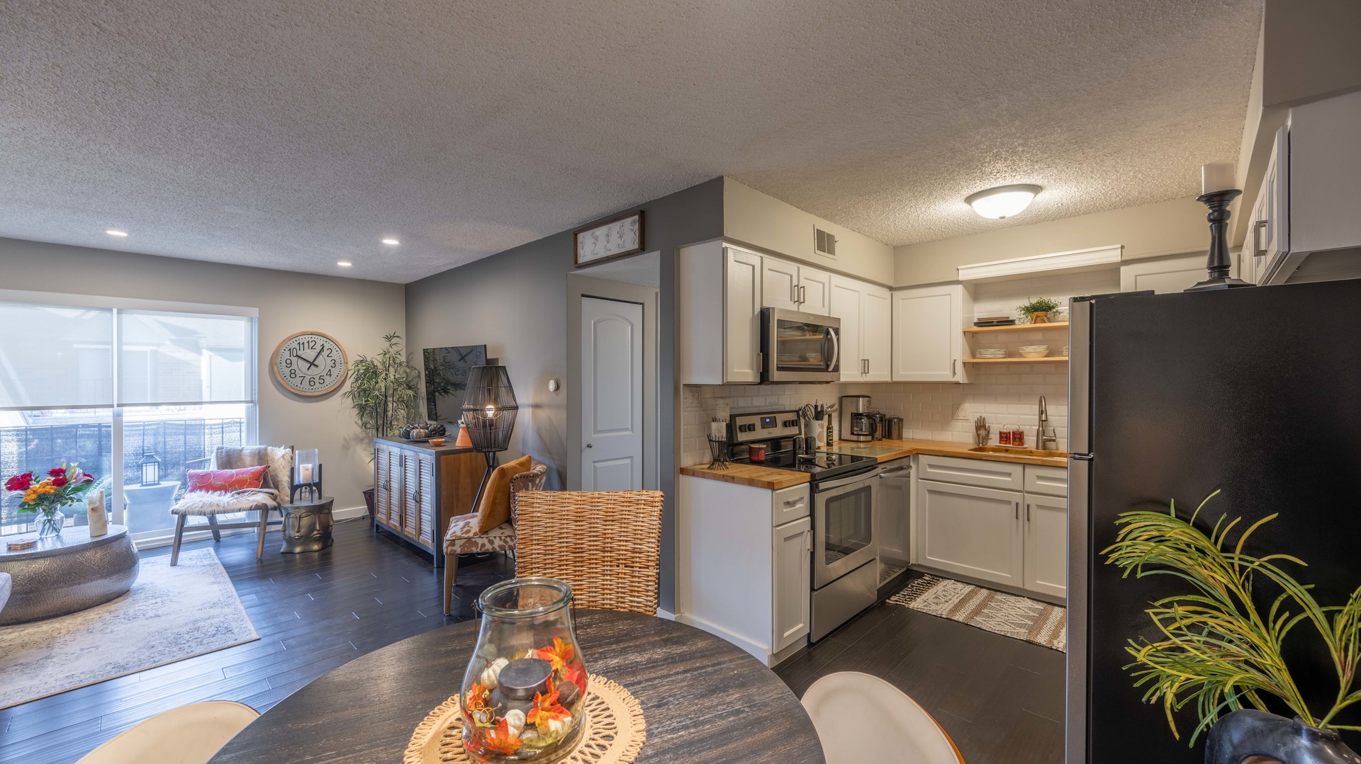 1234 Chalet Road, Unit 301 Naperville, IL 60563 - Photo 4 of 18 a kitchen with stainless steel appliances granite countertop a refrigerator a stove top oven a sink dishwasher and couches with wooden floor