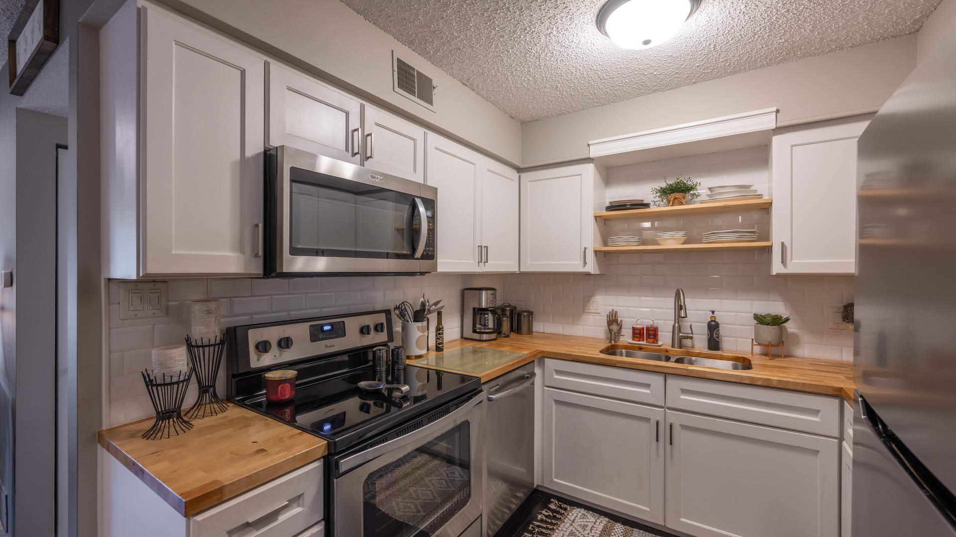1234 Chalet Road, Unit 301 Naperville, IL 60563 - Photo 9 of 18 a kitchen with stainless steel appliances a stove a sink and a microwave