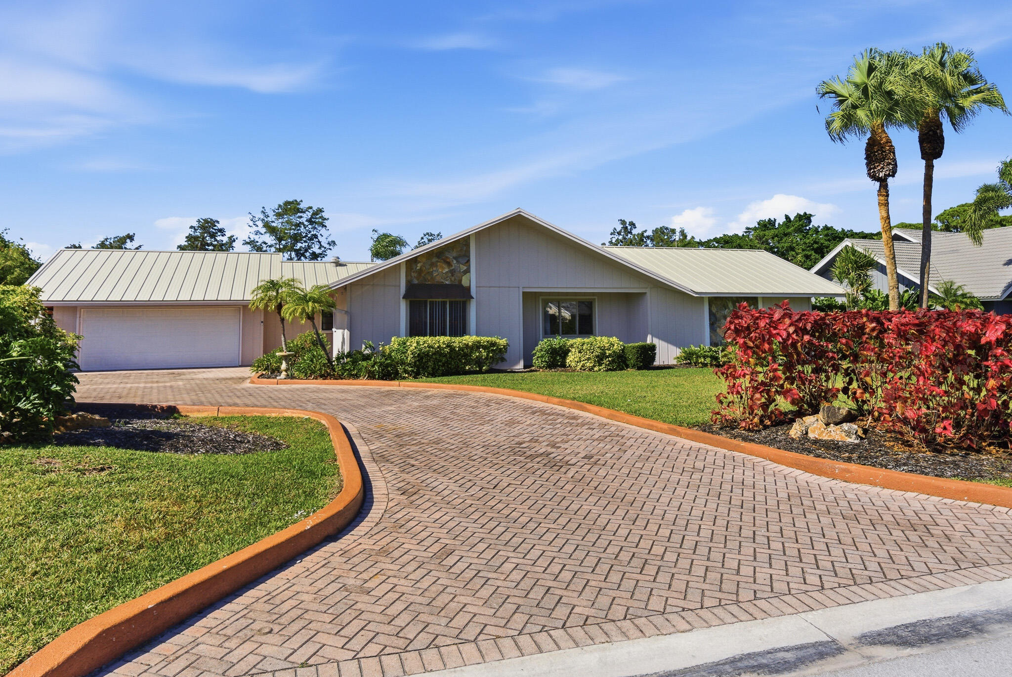 a front view of a house with a garden