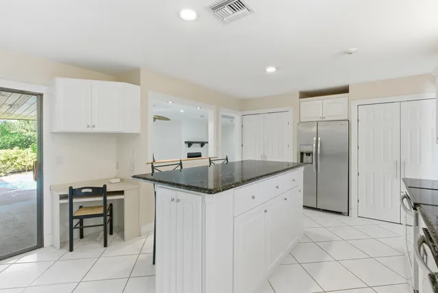 an empty room with windows and ceiling fan