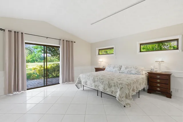 a spacious bedroom with a bed and a couch