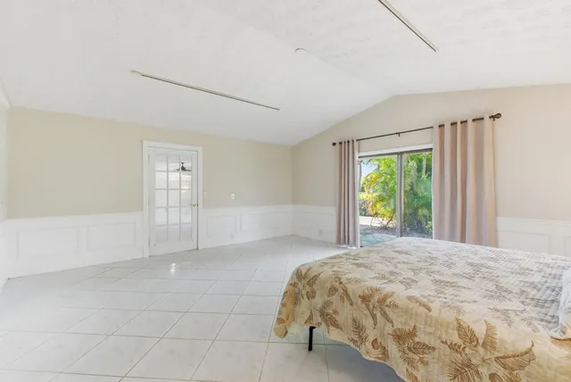 a bedroom with a bed and a lamp