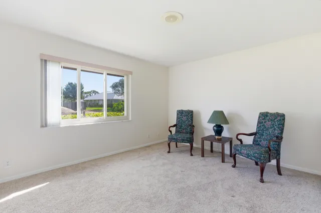 a view of a house with a swimming pool and a yard