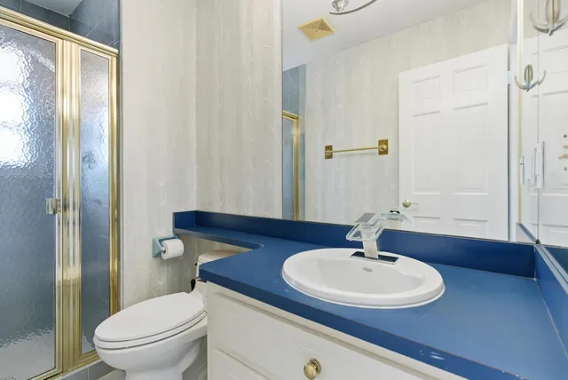 a view of a yellow house with potted plants