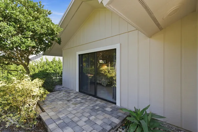 an open kitchen with stainless steel appliances kitchen island granite countertop a table chairs in it and wooden floors