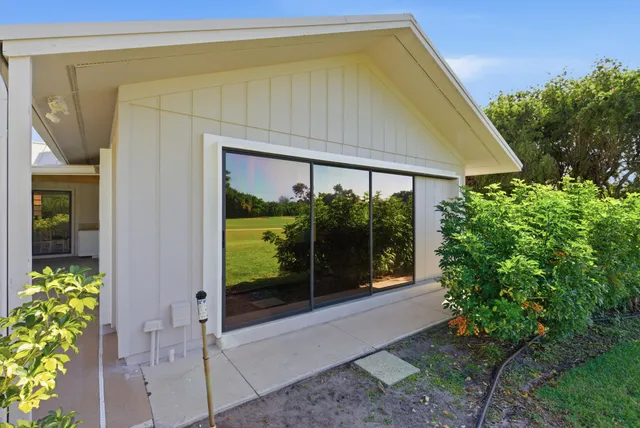 a view of a dining room with furniture a chandelier and wooden floor