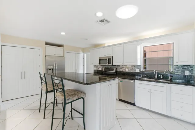 a kitchen with granite countertop a counter space and cabinets