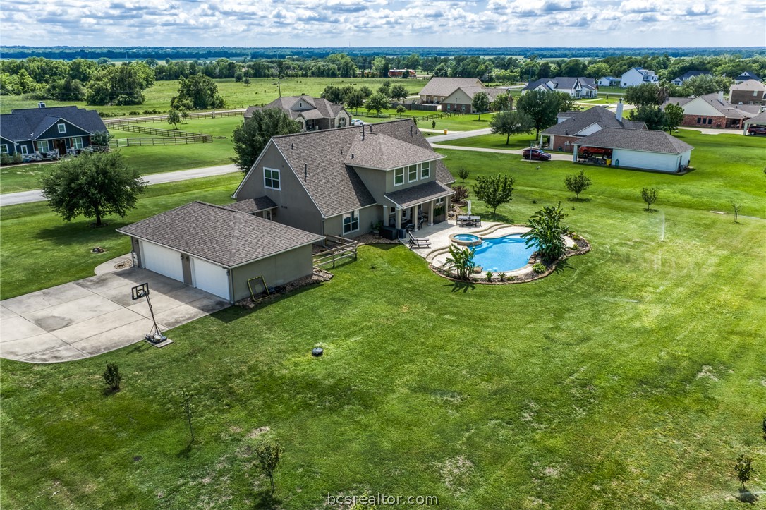 586 Ruby Drive Bellville, TX 77418 - Photo 44 of 50 an aerial view of a house with garden space and outdoor seating