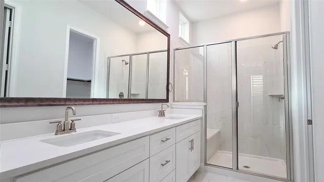 a bathroom with double sink and a mirror