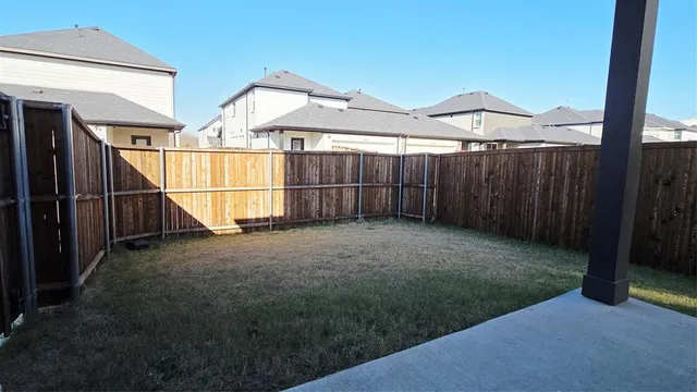 a view of a house with wooden fence