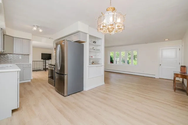 a kitchen with stainless steel appliances a refrigerator and a stove top oven