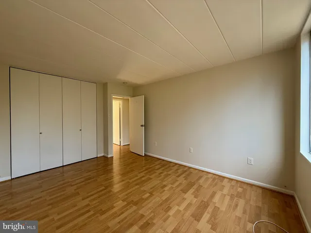 a view of an empty room and wooden floor