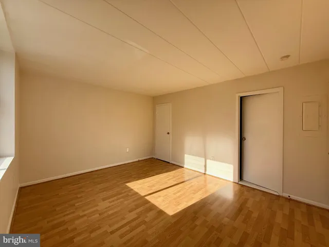 an empty room with wooden floor