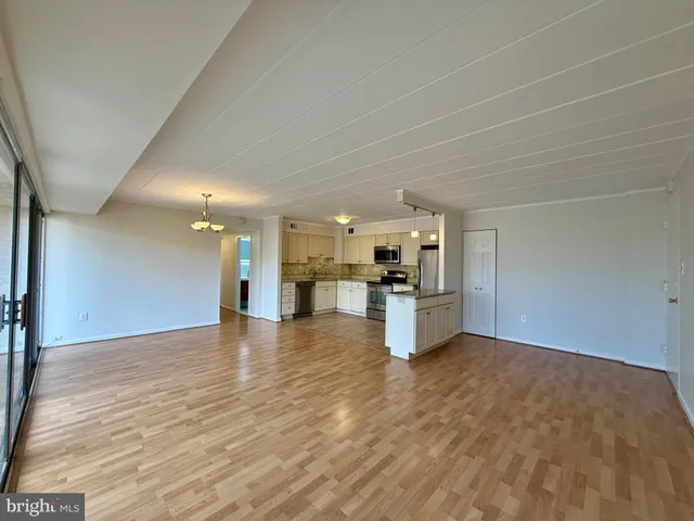 a view of kitchen and kitchen with granite countertop sink