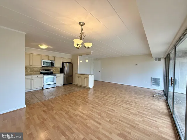 a view of a kitchen with a sink and microwave